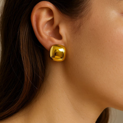 Gold earring worn by a person