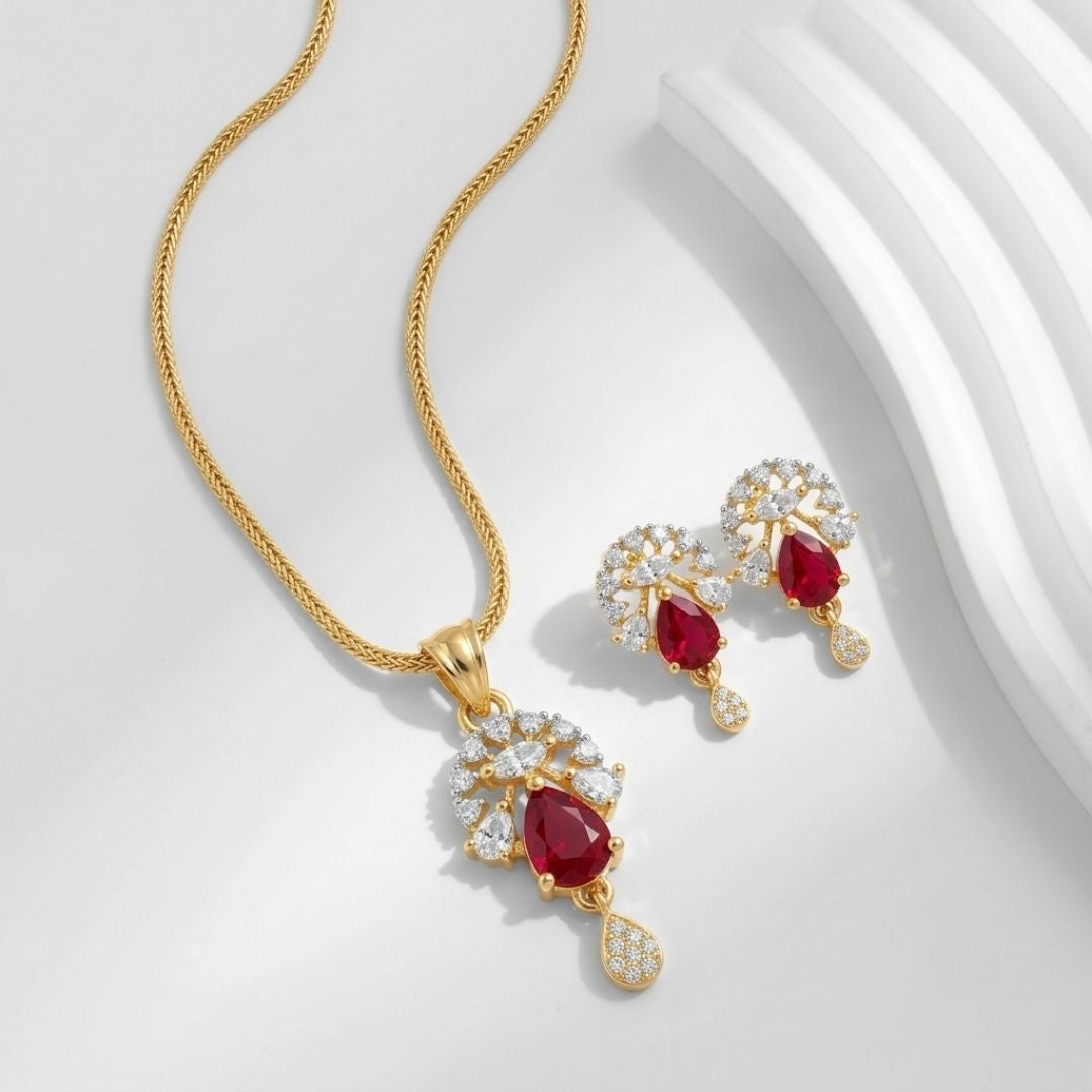 Gold necklace and earring set with pear shaped red stones and clear crystals