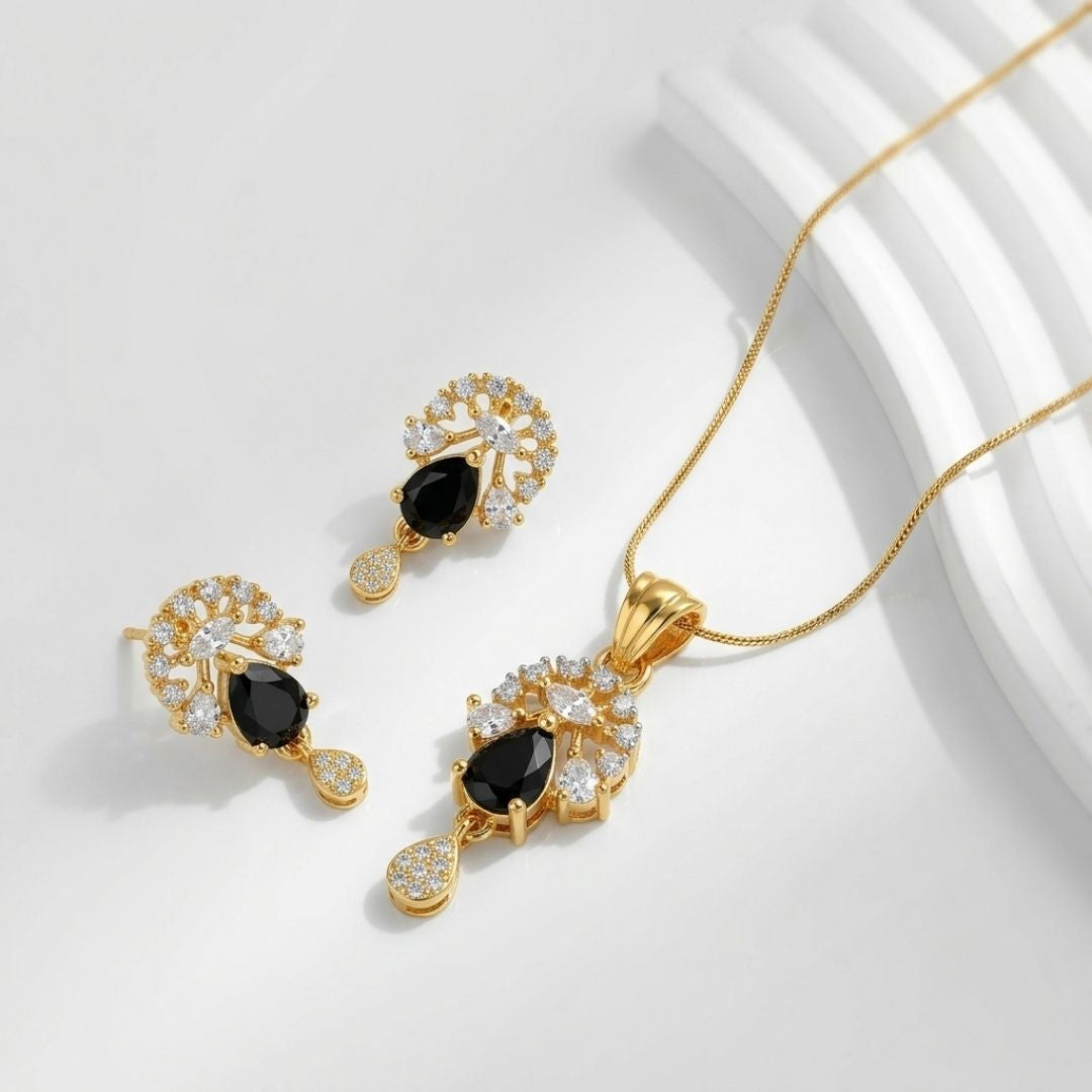 Gold necklace and earring set with black teardrop stones and clear accent crystals