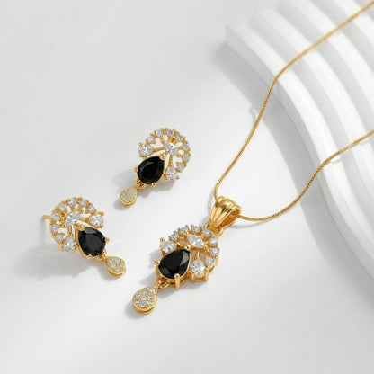 Gold necklace and earring set with black teardrop stones and clear accent crystals