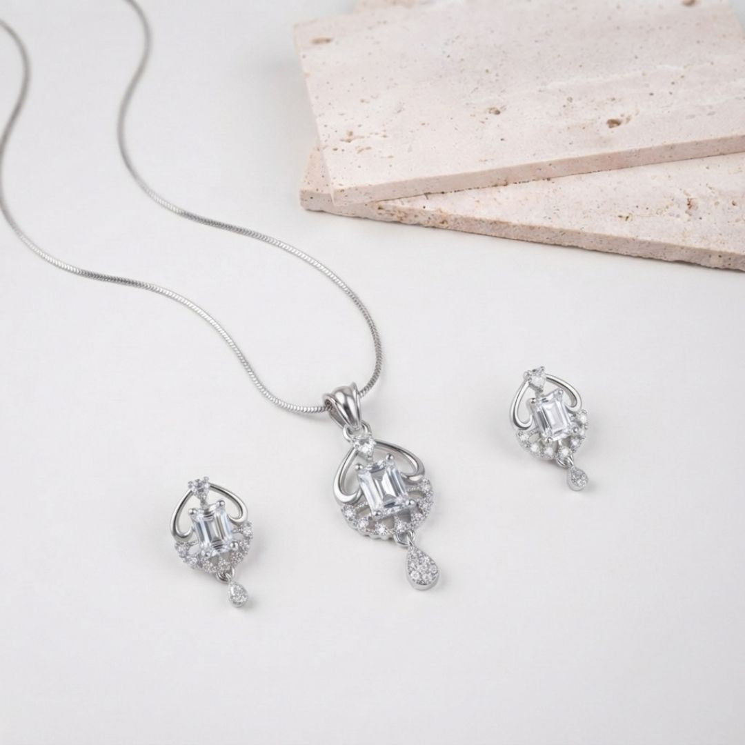 Silver necklace and earring set with emerald cut stones and pave accents