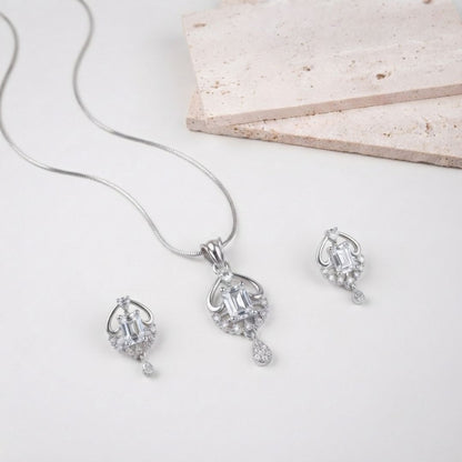 Silver necklace and earring set with emerald cut stones and pave accents