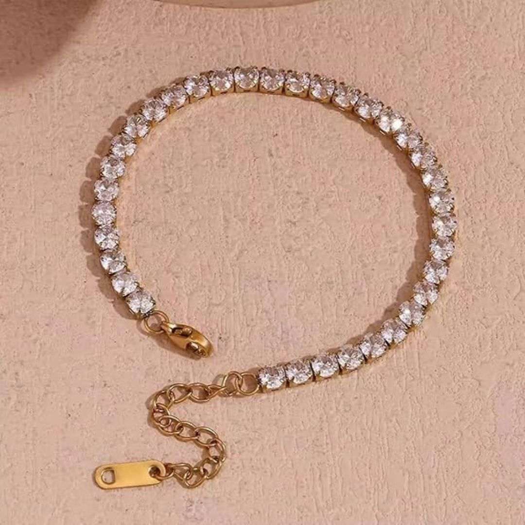 Gold Plated Pendant for Women with clear gemstones on a beige background