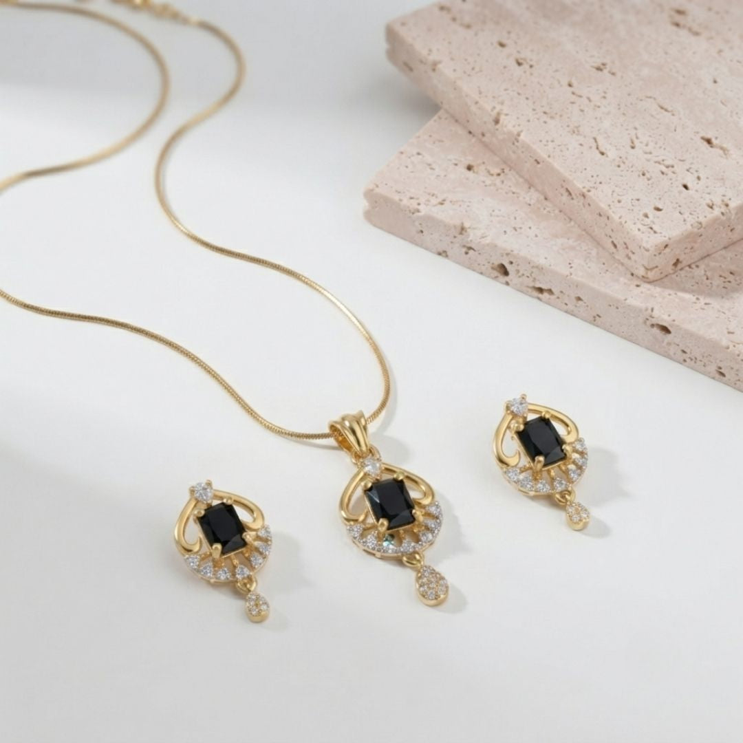 Gold necklace and earring set with black rectangular stones and small clear crystals