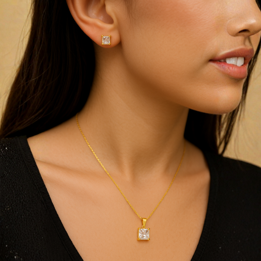 Gold Pendant for Women with a single pearl on a dark fabric background