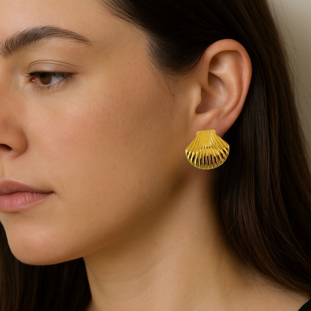 Gold earring worn by a person