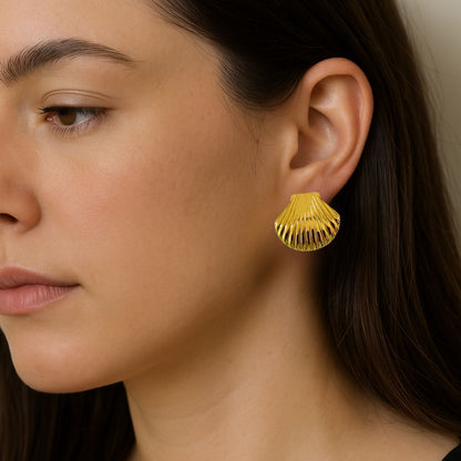 Gold earring worn by a person