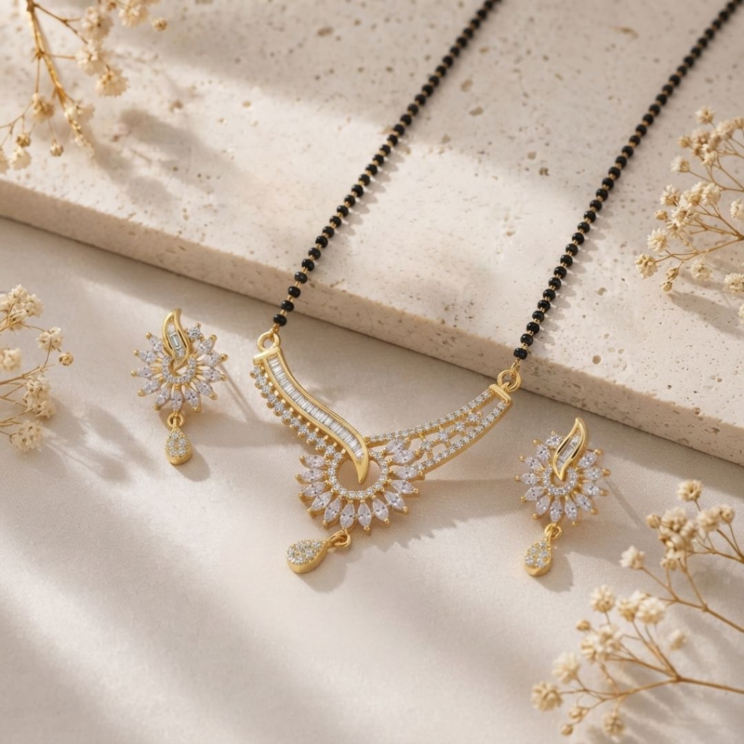 An elegant mangalsutra featuring a curved design adorned with sparkling American diamonds, displayed alongside matching earrings.
