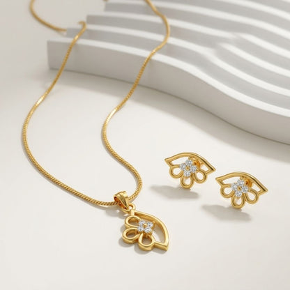 Gold necklace and matching stud earrings with flower shaped pendants featuring small white stones