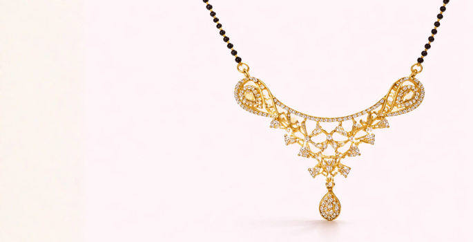 Gold necklace with black beads and a pearl on a pink background