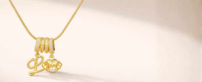 Gold necklace with a pendant on a beige background