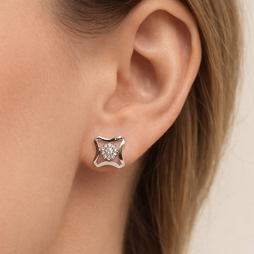Close-up of a diamond AD Earrings for Women on an ear with a neutral background