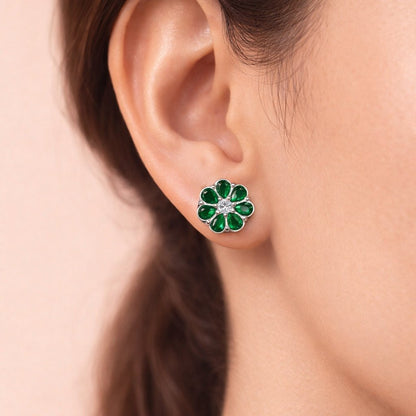 Close-up of an ear wearing a green floral AD Earrings for Women on a neutral background