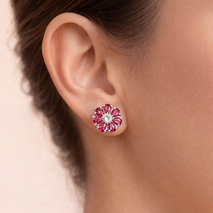 Close-up of an ear wearing a floral AD Earrings for Women with pink gemstones on a neutral background