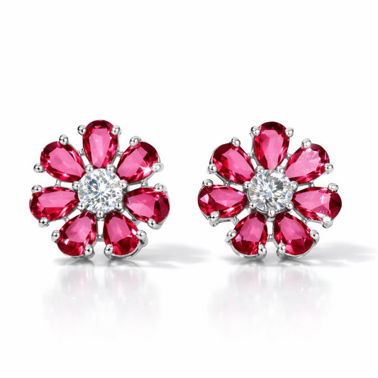 Pair of AD Earrings for Women with red gemstones and a central clear gemstone on a white background