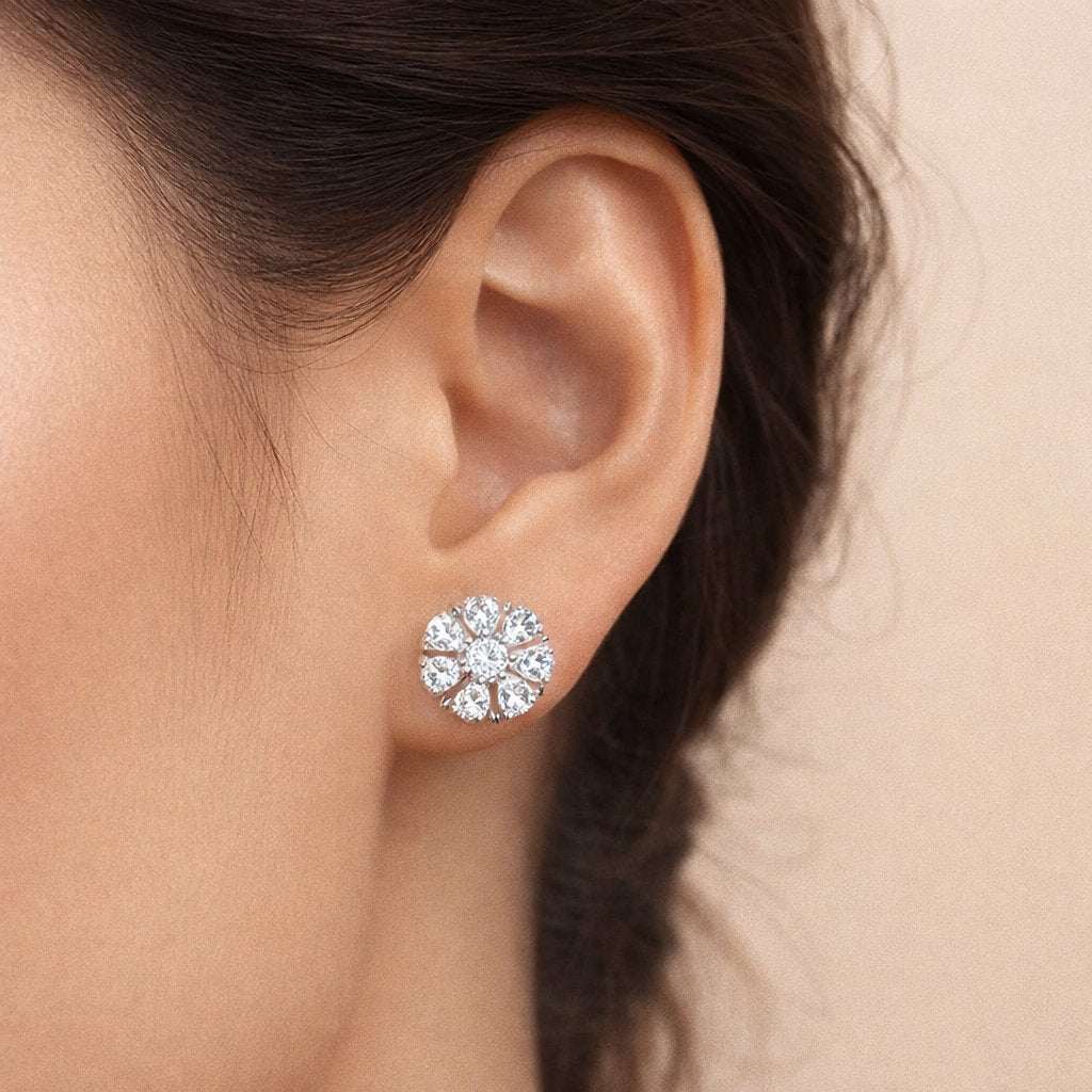 Close-up of an ear wearing a diamond stud AD Earrings for Women with a neutral background