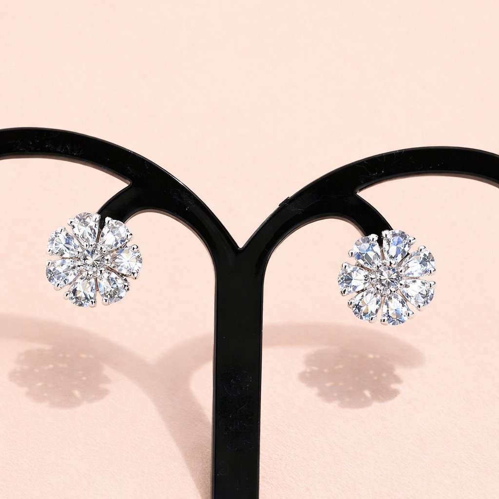 Diamond AD Earrings for Women on a black earring stand with a soft pink background