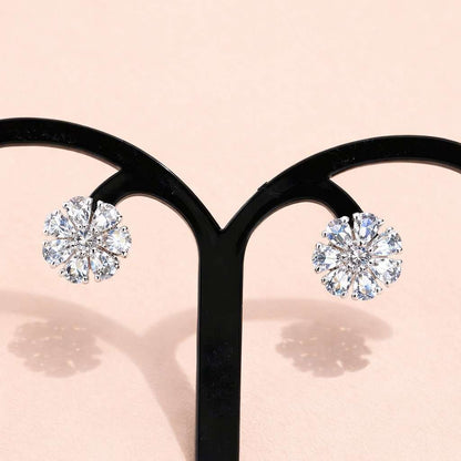 Diamond AD Earrings for Women on a black earring stand with a soft pink background