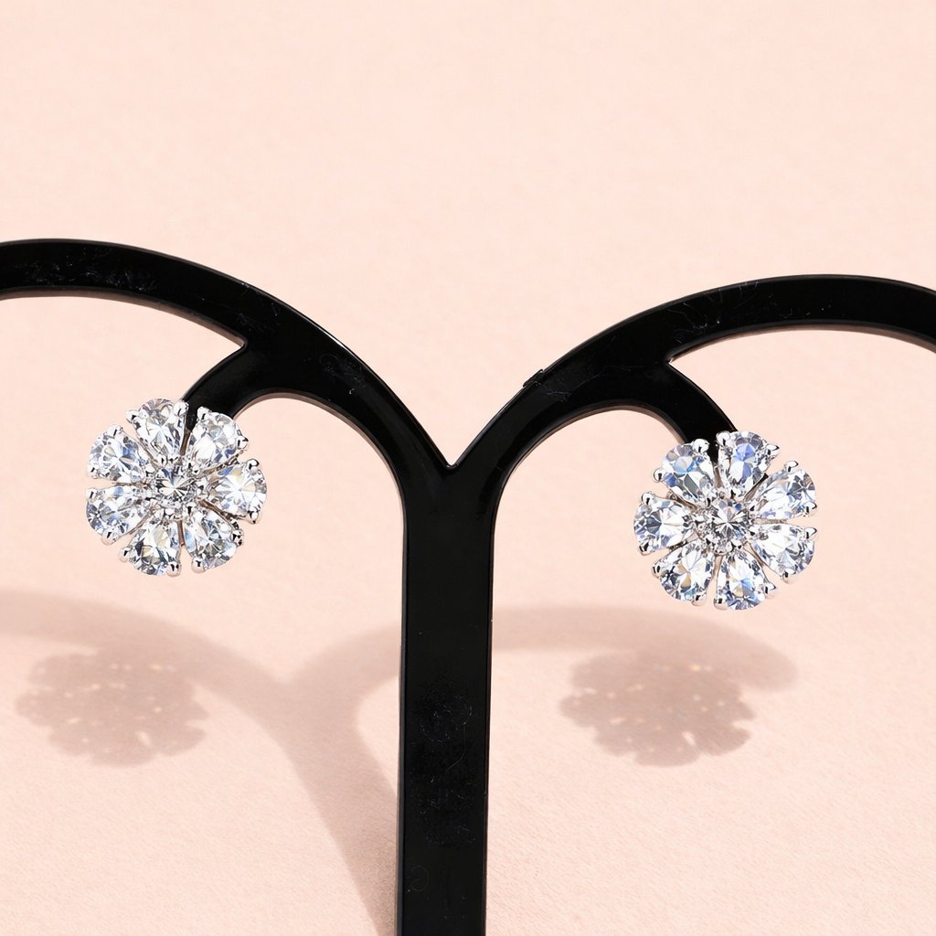 Diamond AD Earrings for Women on a black earring stand with a soft pink background