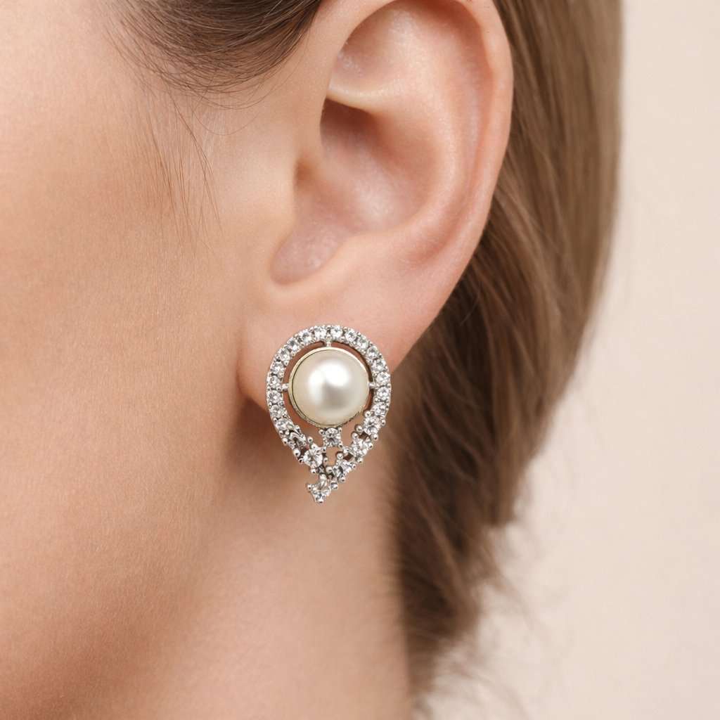Pearl AD Earrings for Women with silver and crystal accents on a light pink background