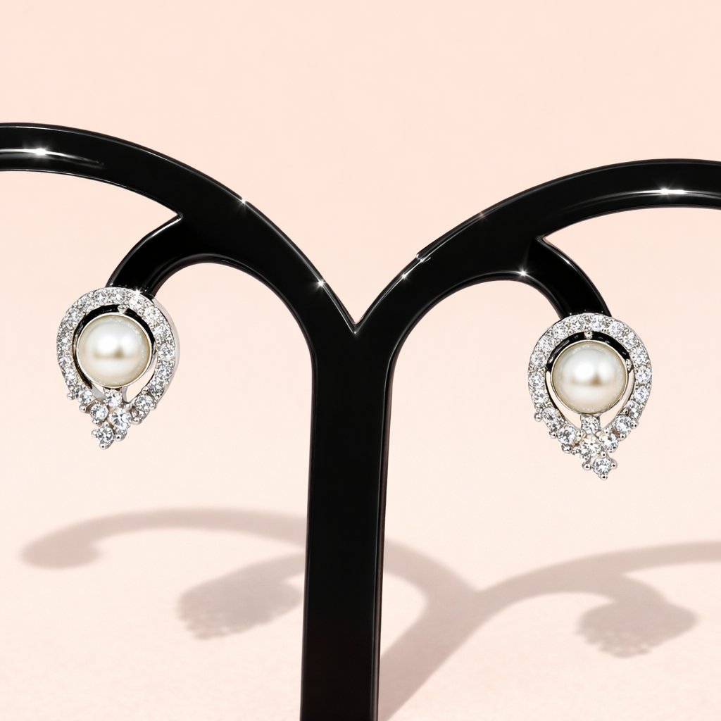 Pearl AD Earrings for Women with silver and crystal accents on a light pink background