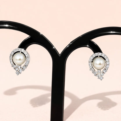 Pearl AD Earrings for Women with silver and crystal accents on a light pink background