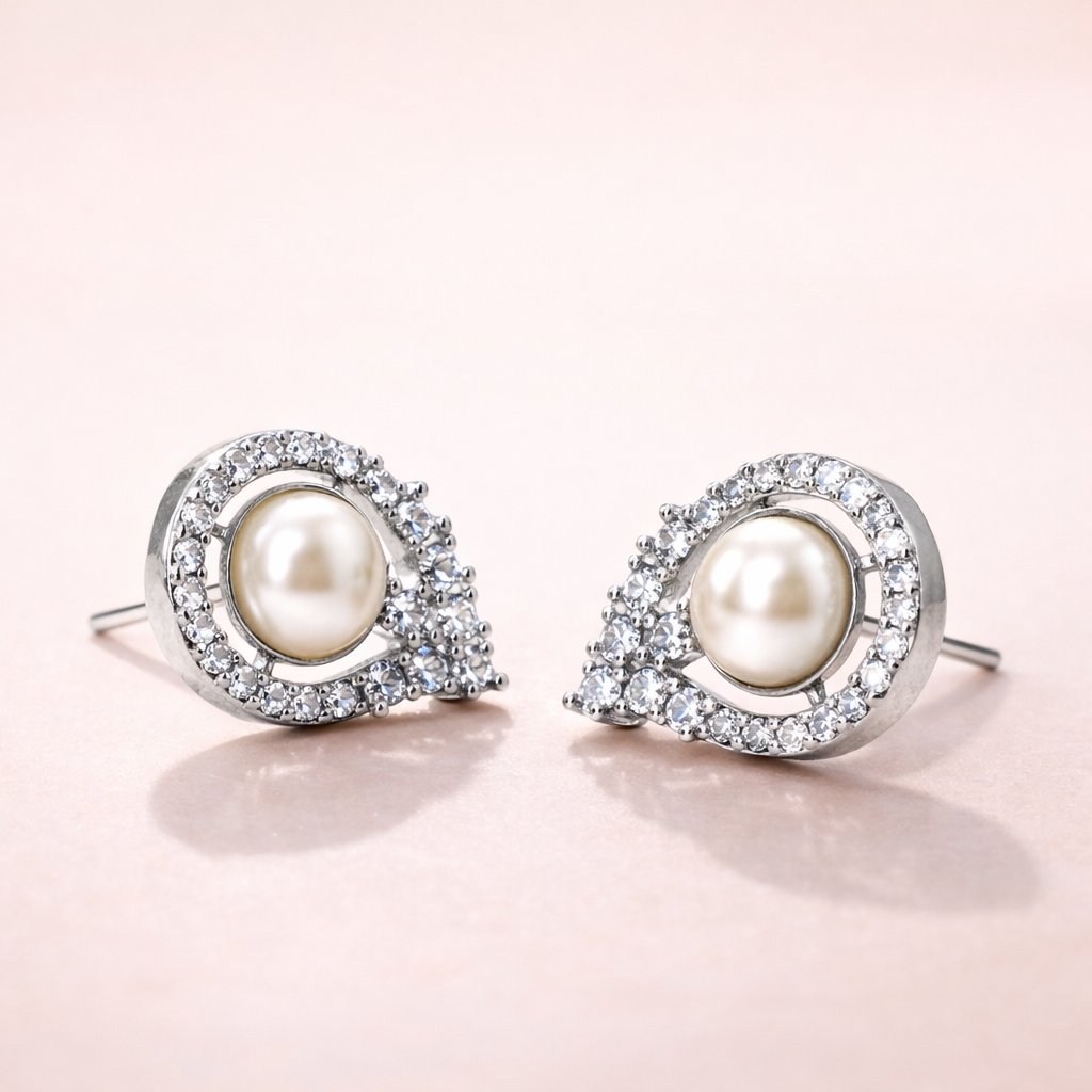 Pearl AD Earrings for Women with silver and crystal accents on a light pink background