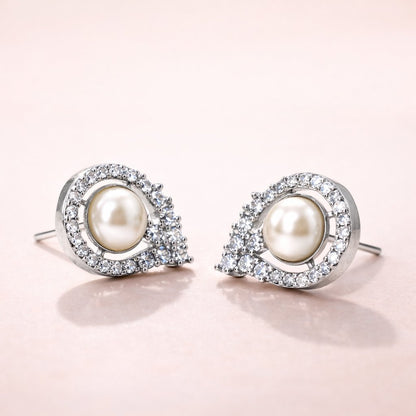 Pearl AD Earrings for Women with silver and crystal accents on a light pink background