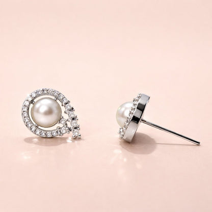 Pearl AD Earrings for Women with diamond accents on a pink background