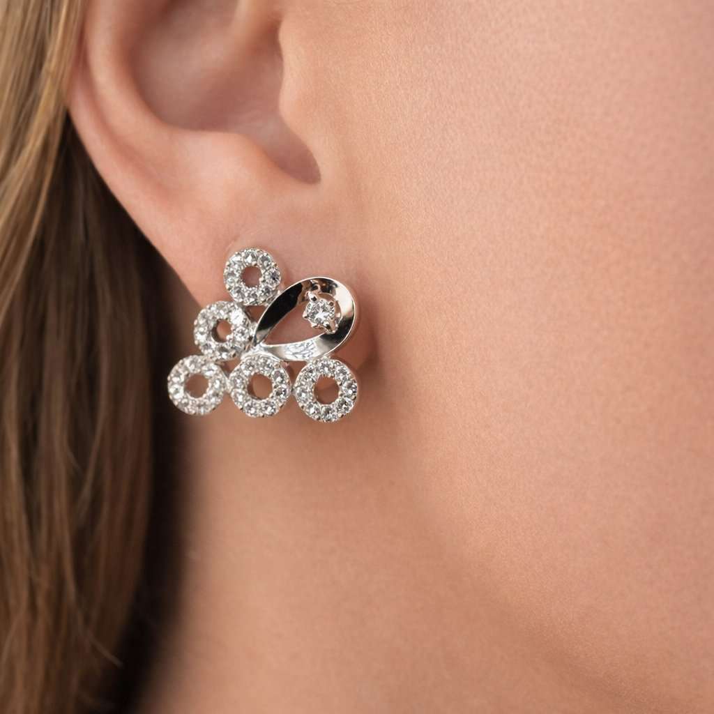 Silver AD Earrings for Women worn on a person's ear with a close-up view.