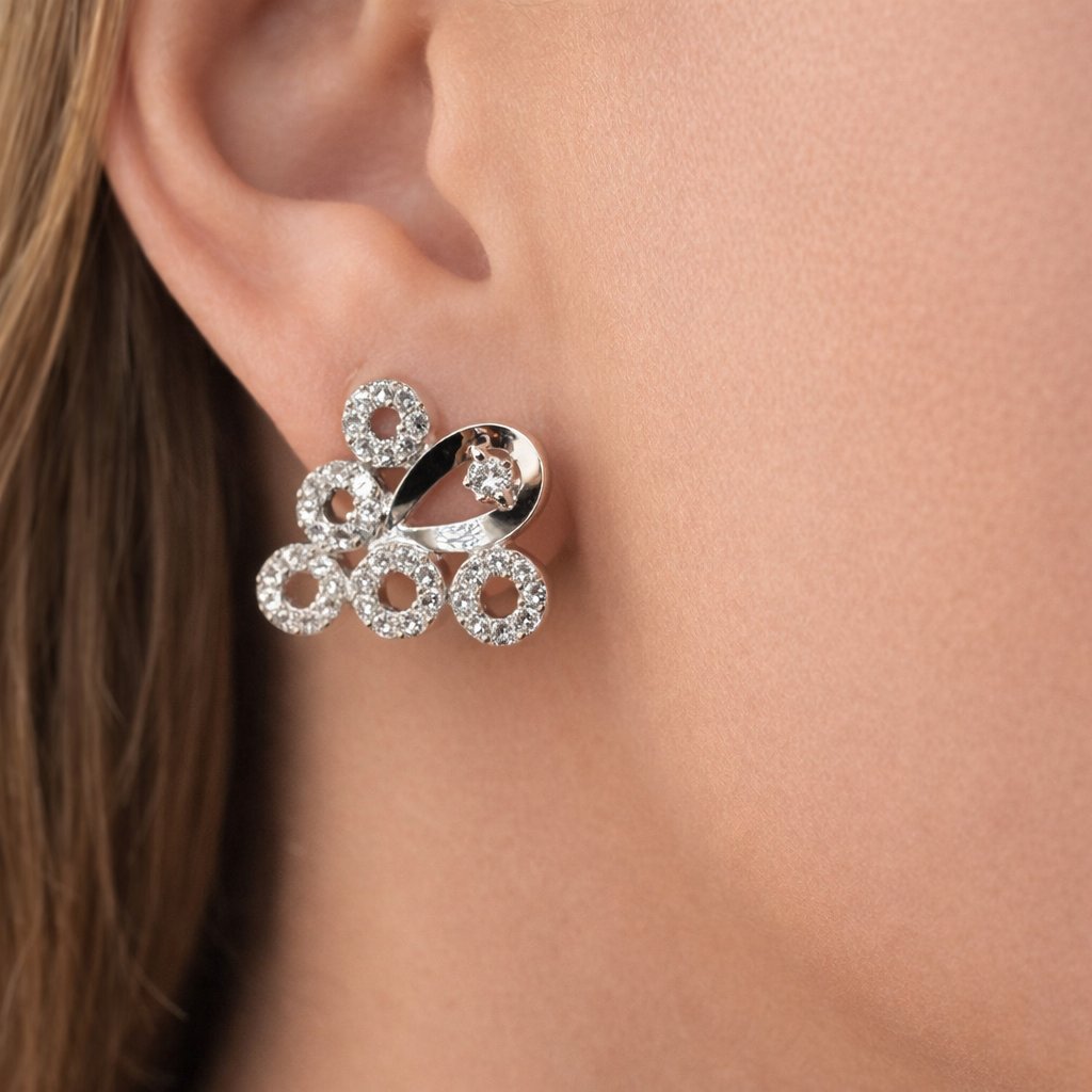 Silver AD Earrings for Women worn on a person's ear with a close-up view.