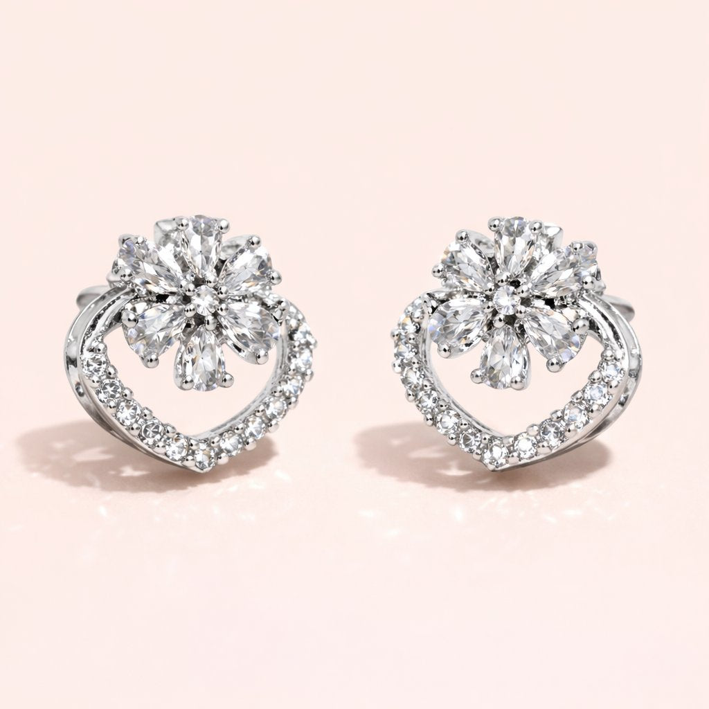Pair of diamond earrings on a light pink background