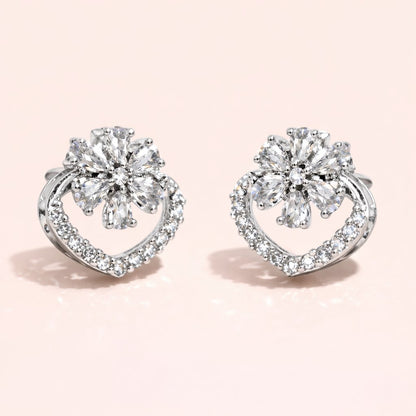 Pair of diamond earrings on a light pink background