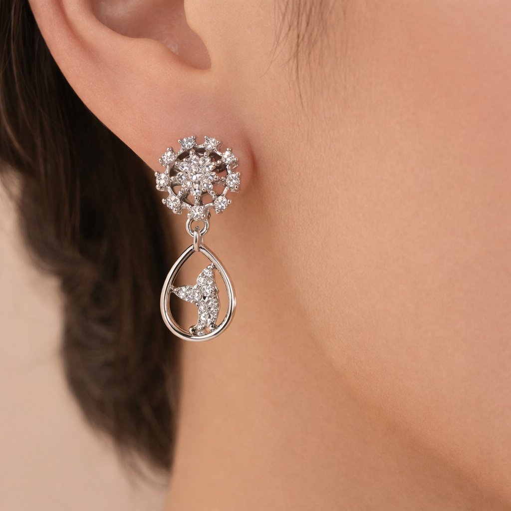 Silver AD Earrings for Women with star and teardrop design worn by a person.
