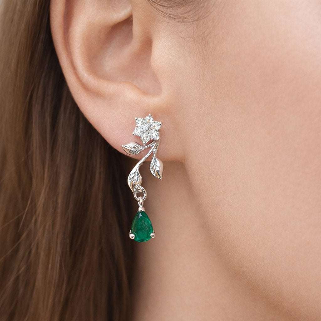 Silver AD Earrings for Women with green gemstone worn by a person