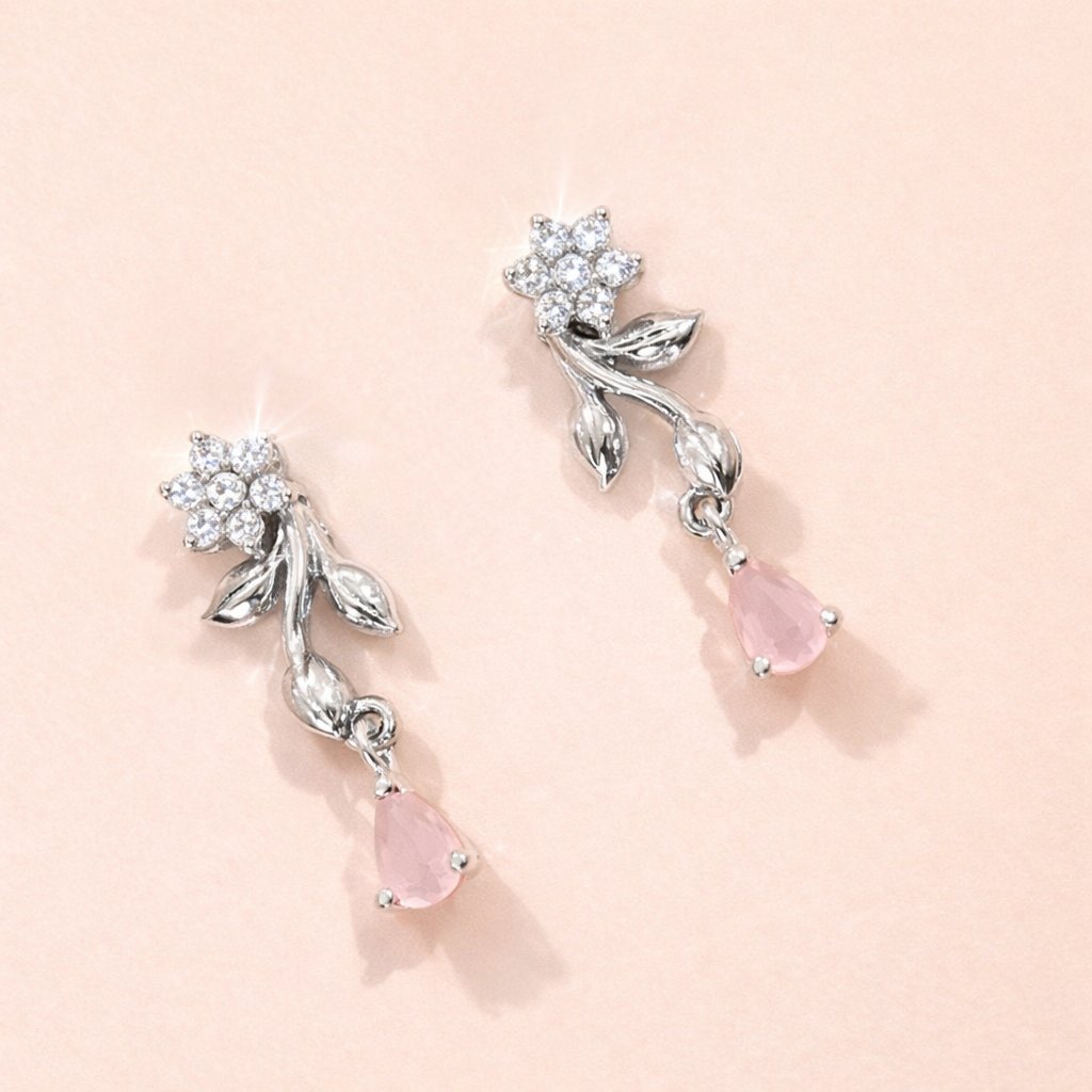 Silver AD Earrings for Women with pink gemstones on a light pink background