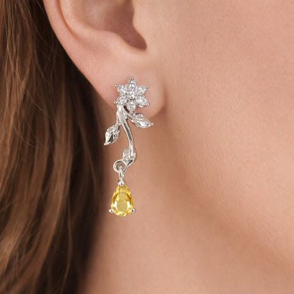 Silver AD Earrings for Women with yellow teardrop gemstone worn by a person