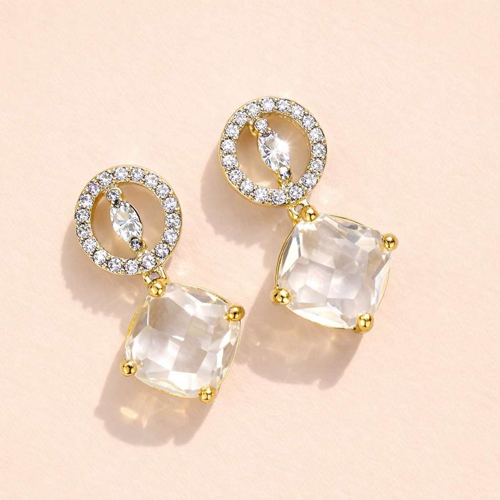 Gold AD Earrings for Women with clear gemstones on a beige background