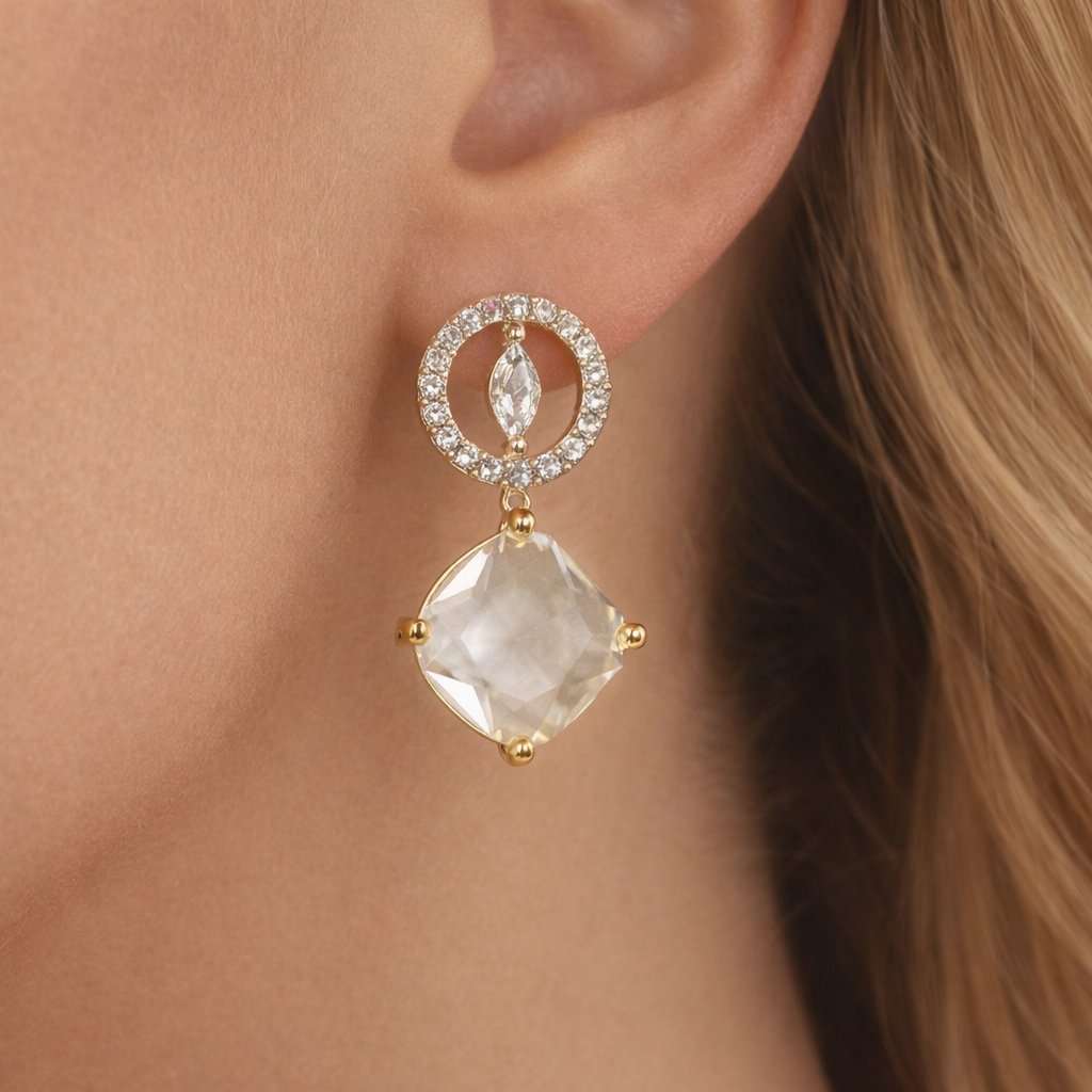 AD Earrings for Women with a clear gemstone and gold accents worn by a person with blonde hair.