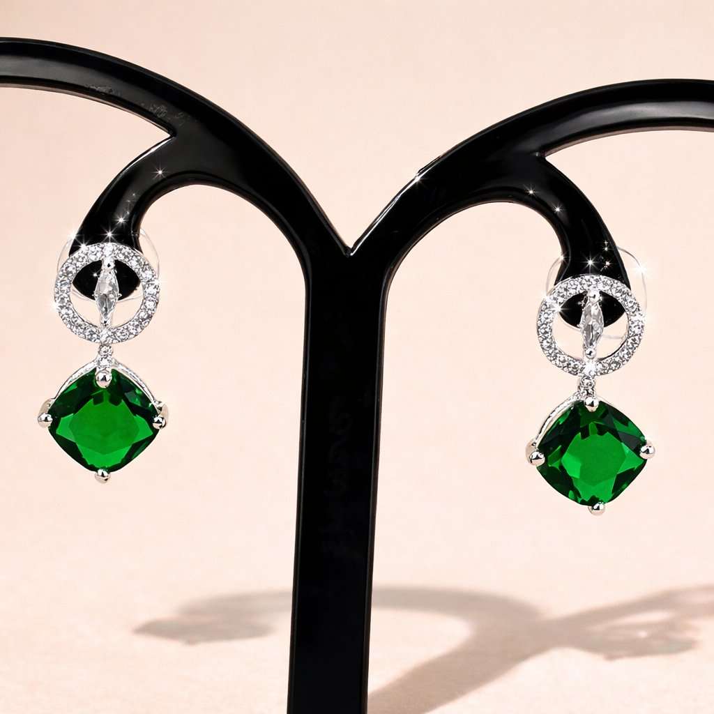 Green gemstone AD Earrings for Women on a black stand with a beige background