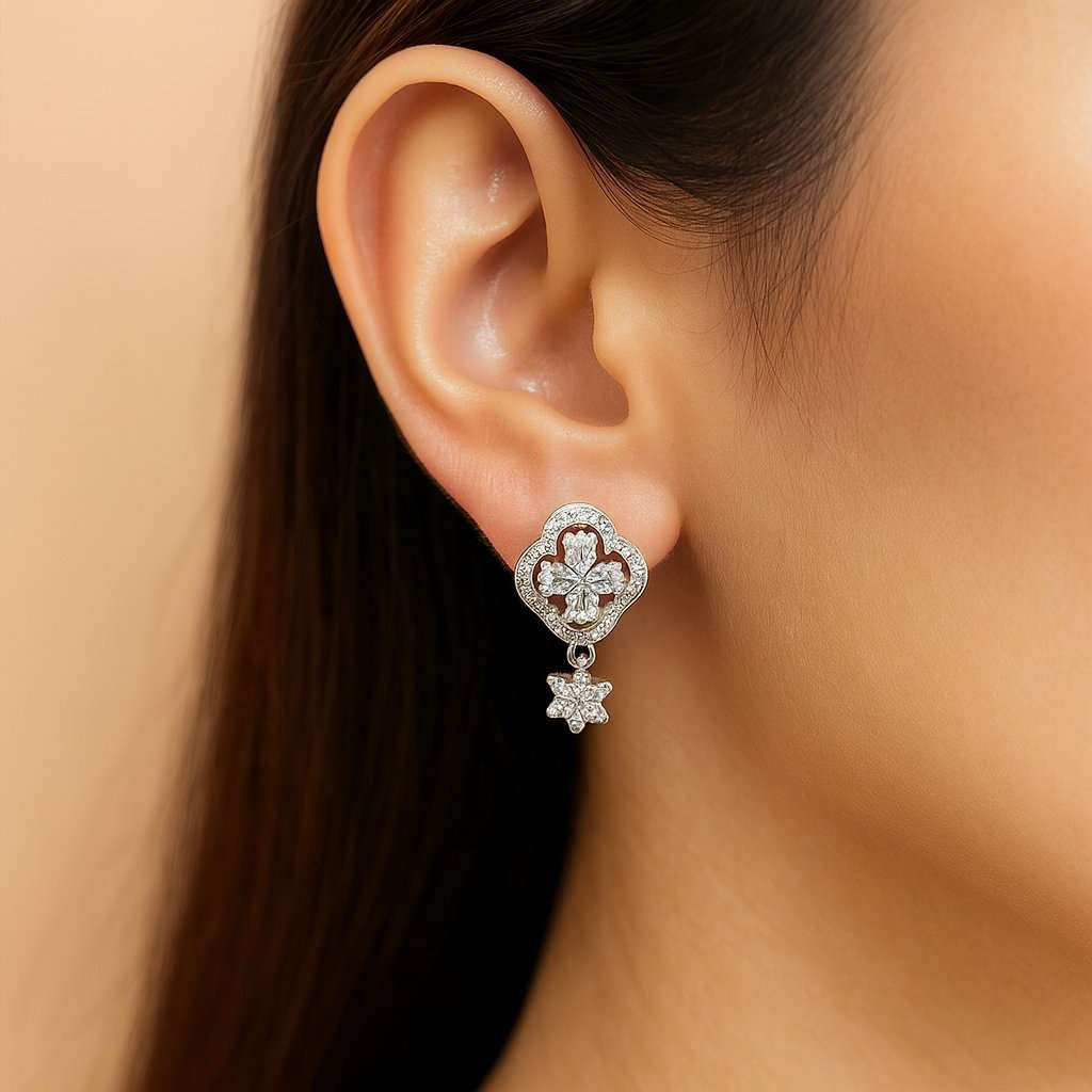 Pair of silver AD Earrings for Women with green gemstones on a white background