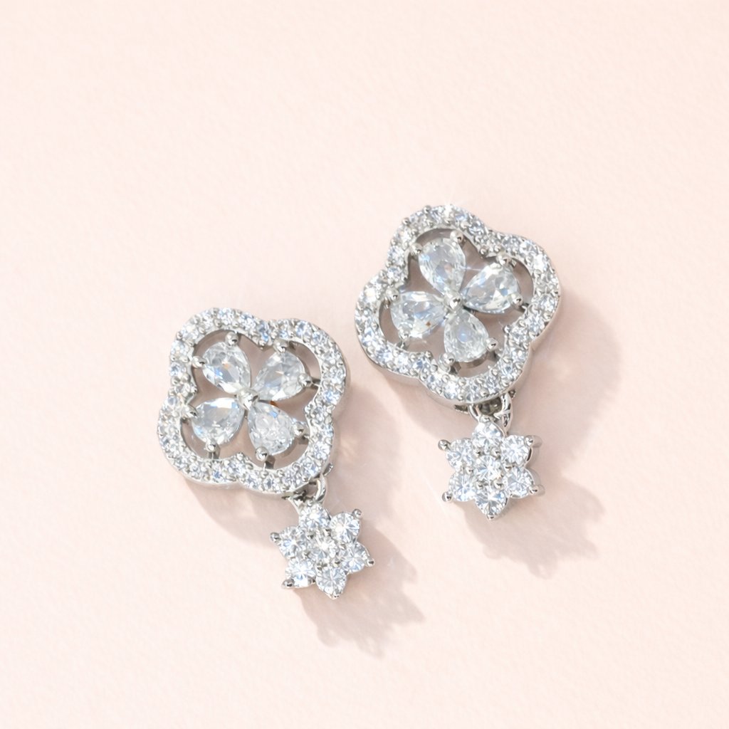 Pair of diamond AD Earrings for Women on a light pink background
