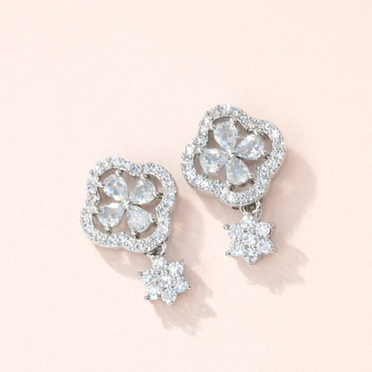 Pair of diamond AD Earrings for Women on a light pink background