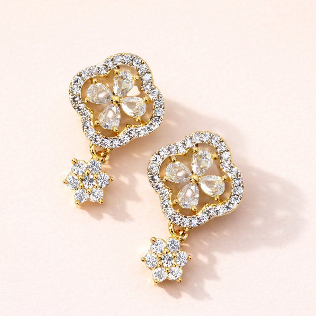 Gold and diamond AD Earrings for Women on a light pink background