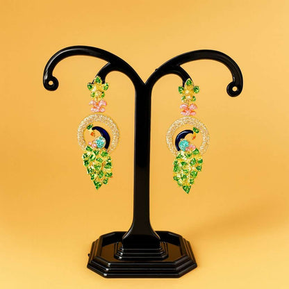 Pair of AD Earrings for Women with green and pink stones on a black stand against a yellow background