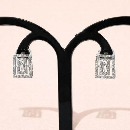 Diamond AD Earrings for Women on a black stand with a pink background