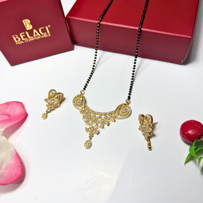 Gold AD Mangalsutra with matching earrings on a white surface with a Belaci box in the background.