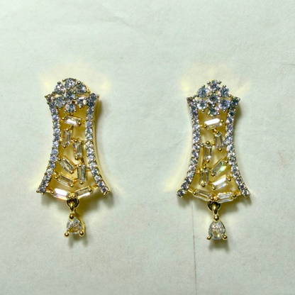 Gold AD earrings with clear gemstones on a light gray background