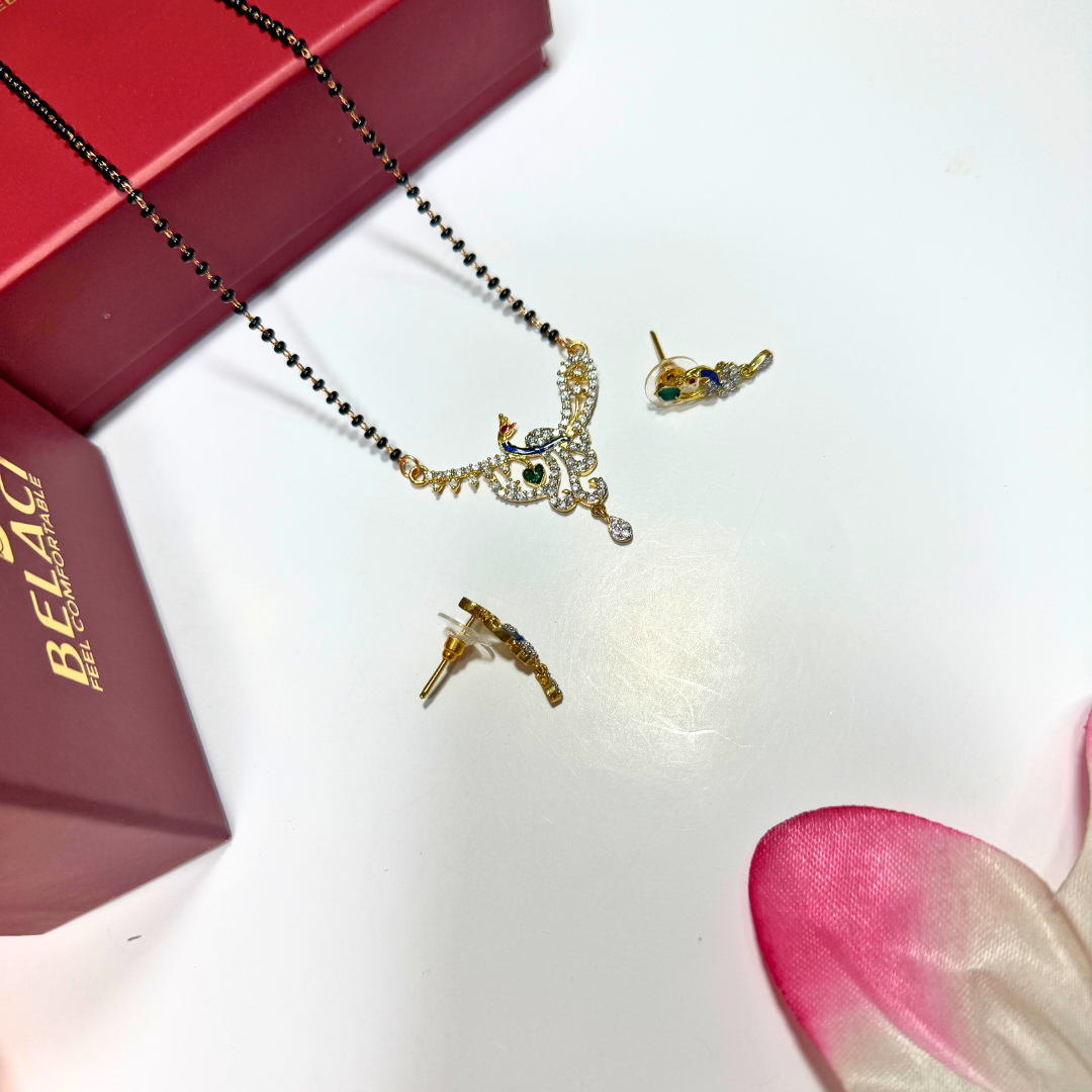Gold AD Mangalsutra and earrings on a white surface with a red box and pink flower petal.