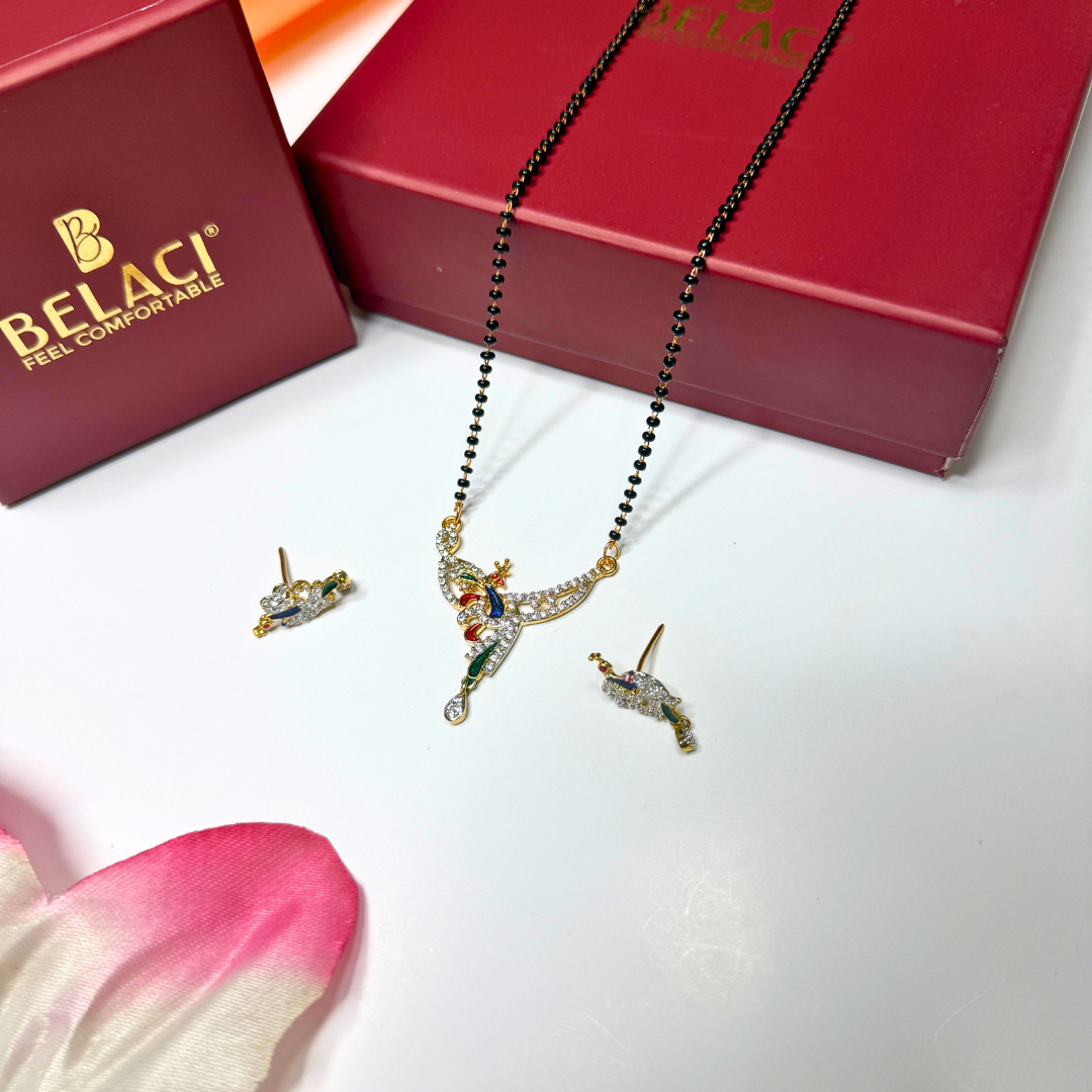 AD Mangalsutra Jewelry set with necklace and earrings on a white surface, Belaci box in the background.